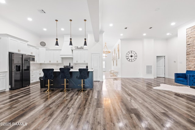 1114 Dermelie Calais Rd, Breaux Bridge, LA 70517 - kitchen with fridge with ice dispenser, custom exhaust hood, light countertops, open floor plan, and decorative backsplash
