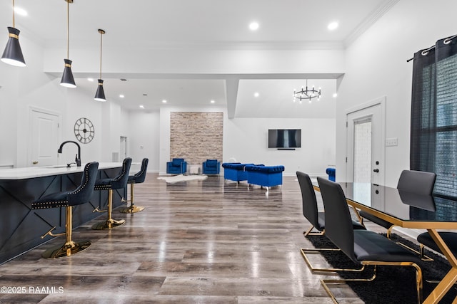 1114 Dermelie Calais Rd, Breaux Bridge, LA 70517 - misc room with crown molding, wood finished floors, a chandelier, recessed lighting, and a towering ceiling