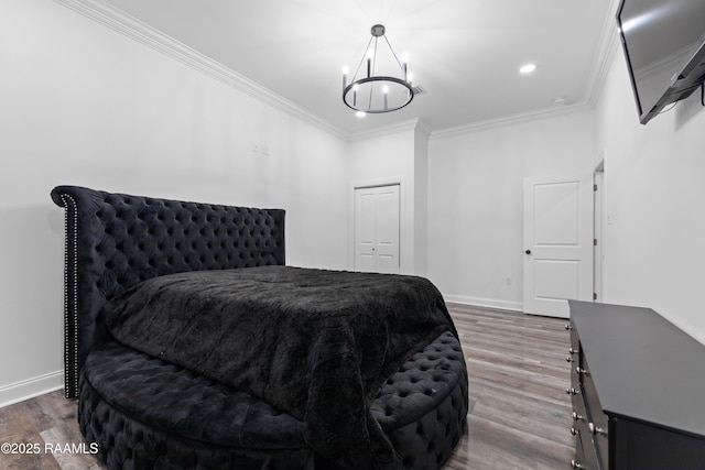 1114 Dermelie Calais Rd, Breaux Bridge, LA 70517 - bedroom with a chandelier, ornamental molding, wood finished floors, recessed lighting, and a closet