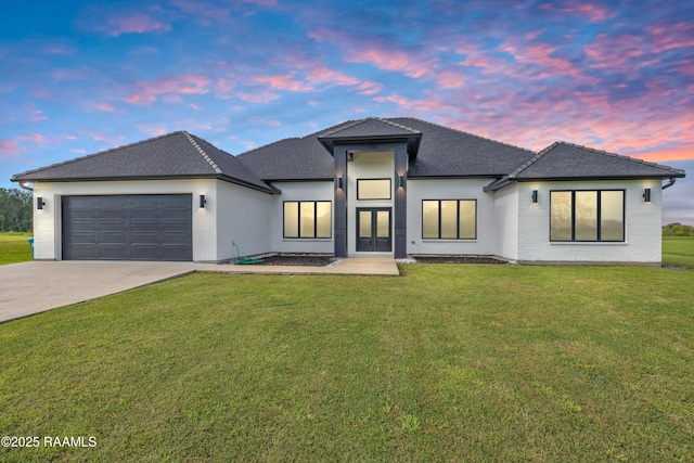 1114 Dermelie Calais Rd, Breaux Bridge, LA 70517 - view of front of home featuring brick siding, an attached garage, driveway, and a yard