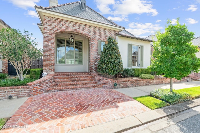 106 Brickell Way, Lafayette, LA 70508 - view of exterior entry featuring brick siding, covered porch, and a high end roof