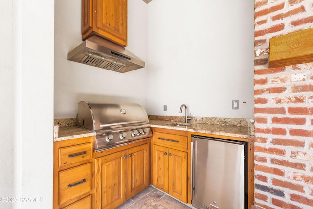 106 Brickell Way, Lafayette, LA 70508 - kitchen featuring fridge, ventilation hood, light stone countertops, and brown cabinets