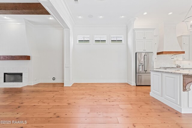 106 Brickell Way, Lafayette, LA 70508 - unfurnished living room featuring ornamental molding, light wood-type flooring, recessed lighting, and a tile fireplace