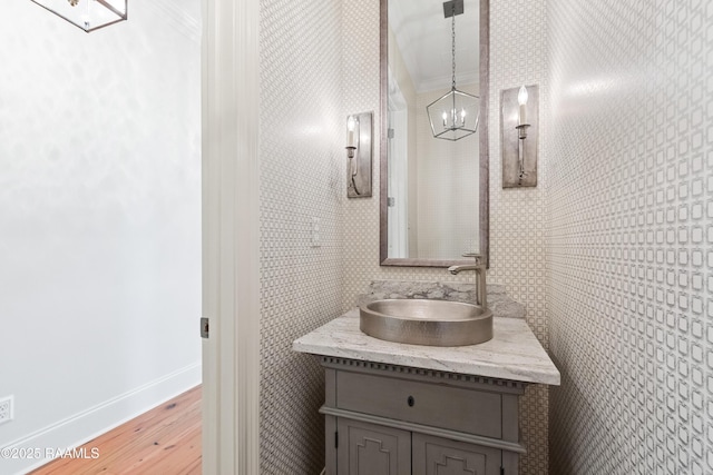 106 Brickell Way, Lafayette, LA 70508 - bathroom featuring wood finished floors, vanity, a chandelier, and ornamental molding