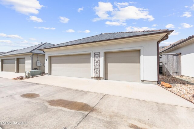 106 Brickell Way, Lafayette, LA 70508 - view of front facade featuring concrete driveway, an outbuilding, and stucco siding