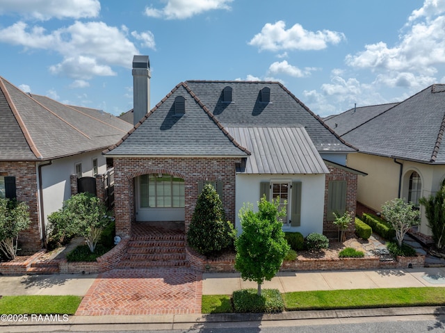 106 Brickell Way, Lafayette, LA 70508 - french provincial home featuring stucco siding, a chimney, and brick siding
