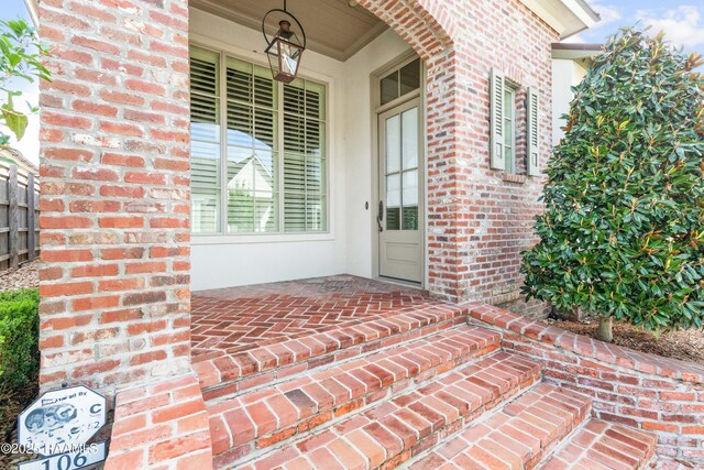 106 Brickell Way, Lafayette, LA 70508 - doorway to property featuring brick siding and covered porch
