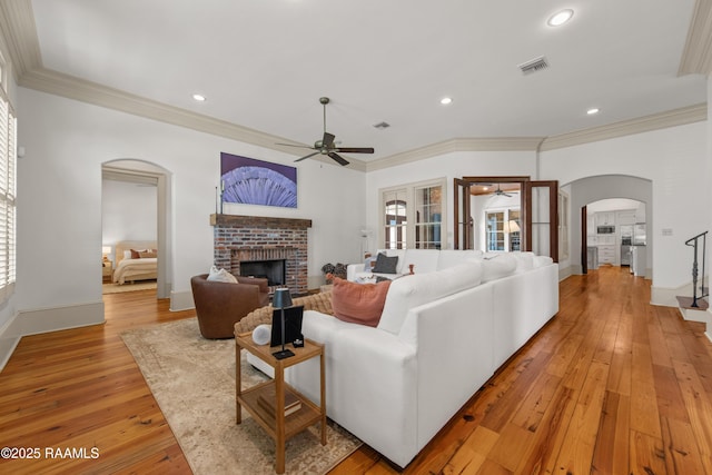 407 Arabella Blvd, Lafayette, LA 70508 - living area featuring arched walkways, ceiling fan, light wood-style floors, a fireplace, and recessed lighting