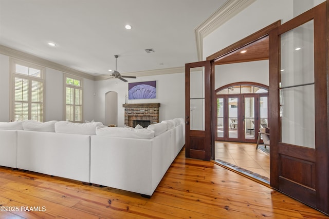 407 Arabella Blvd, Lafayette, LA 70508 - living room featuring crown molding, light wood-style floors, a fireplace, ceiling fan, and recessed lighting