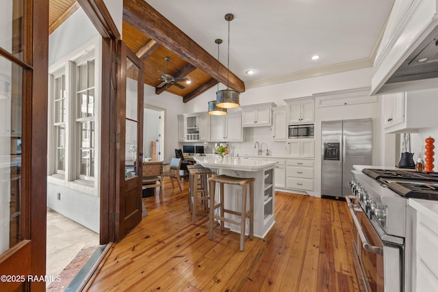 407 Arabella Blvd, Lafayette, LA 70508 - kitchen with custom range hood, appliances with stainless steel finishes, a kitchen breakfast bar, light countertops, and a center island