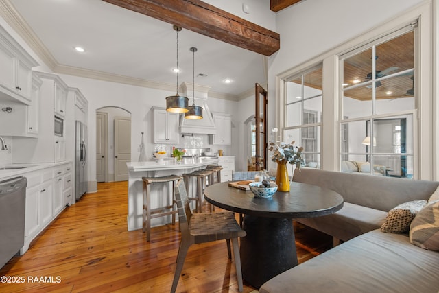407 Arabella Blvd, Lafayette, LA 70508 - dining area featuring arched walkways, light wood-style floors, healthy amount of natural light, ornamental molding, and recessed lighting