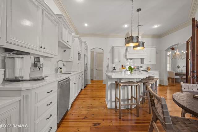 407 Arabella Blvd, Lafayette, LA 70508 - kitchen featuring arched walkways, appliances with stainless steel finishes, light countertops, backsplash, and recessed lighting