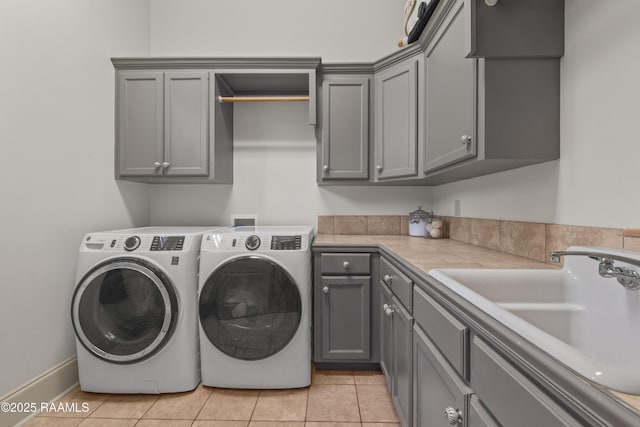 407 Arabella Blvd, Lafayette, LA 70508 - washroom with cabinet space, washing machine and dryer, and light tile patterned floors