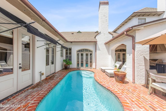 407 Arabella Blvd, Lafayette, LA 70508 - outdoor pool featuring french doors, a patio area, and exterior kitchen