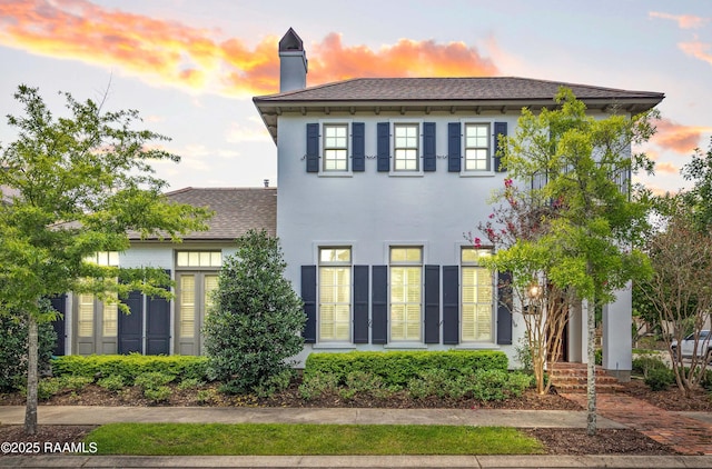 407 Arabella Blvd, Lafayette, LA 70508 - view of front of property featuring a shingled roof, a chimney, and stucco siding