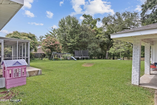 209 Sandager Ave, Jeanerette, LA 70544 - view of yard with a trampoline, a playground, a sunroom, and a patio area
