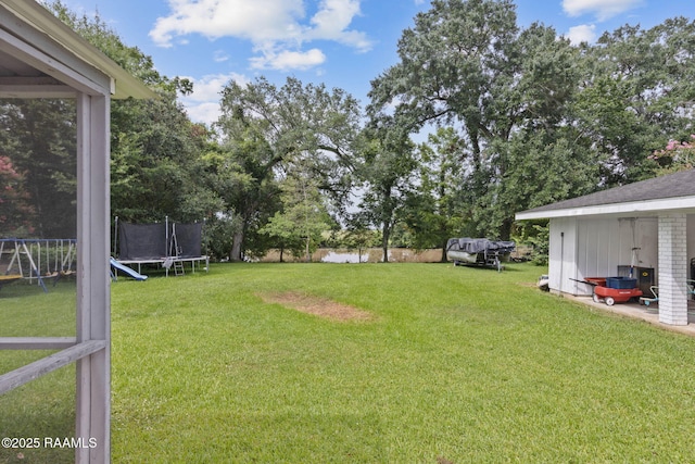 209 Sandager Ave, Jeanerette, LA 70544 - view of yard featuring a trampoline and a playground