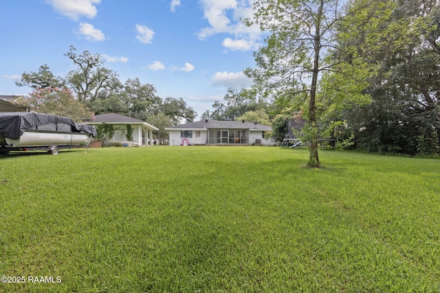 209 Sandager Ave, Jeanerette, LA 70544 - view of green lawn featuring a trampoline