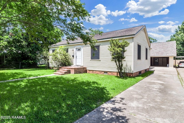 707 Compton St, New Iberia, LA 70560 - view of front of house with crawl space, an outbuilding, concrete driveway, a front yard, and roof with shingles