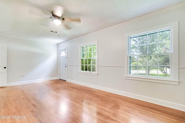 707 Compton St, New Iberia, LA 70560 - spare room with crown molding, light wood finished floors, plenty of natural light, ceiling fan, and a textured ceiling