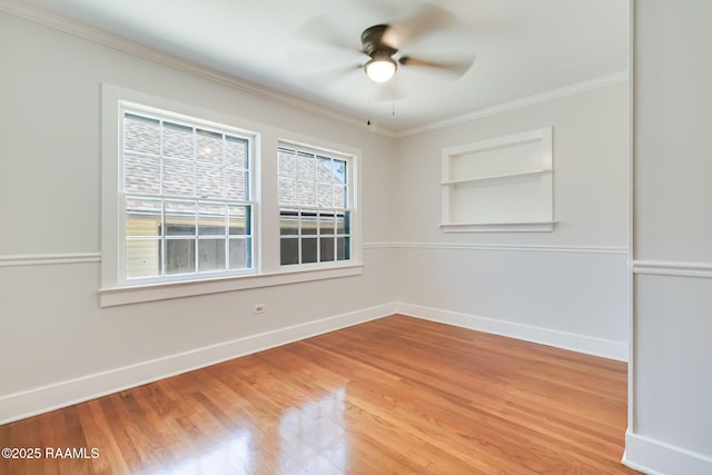 707 Compton St, New Iberia, LA 70560 - spare room with crown molding, a ceiling fan, light wood-style floors, and built in shelves