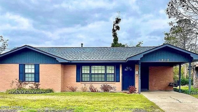 1317 N N Elton Ct, Lake Charles, LA 70607 - ranch-style home featuring driveway, a front yard, a carport, brick siding, and roof with shingles