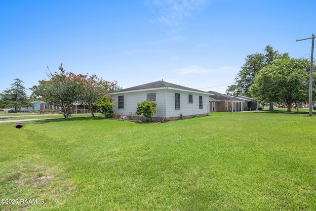 701 Ledoux St, Jennings, LA 70546 - view of side of home with a yard