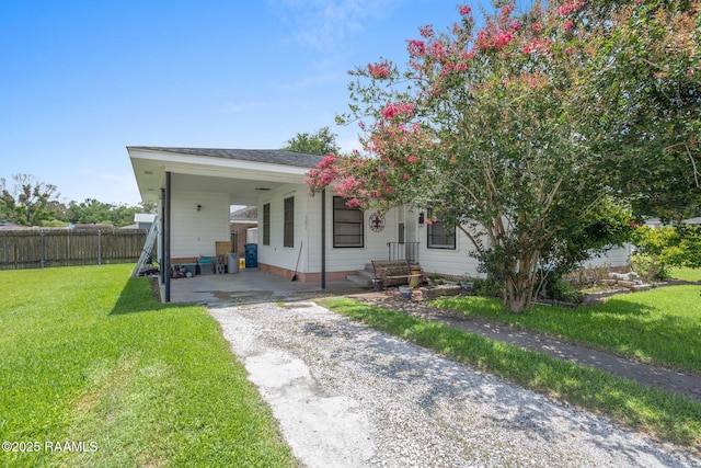 701 Ledoux St, Jennings, LA 70546 - view of front of house with an attached carport and gravel driveway