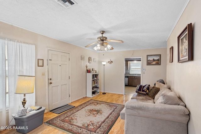701 Ledoux St, Jennings, LA 70546 - living area featuring ceiling fan, a textured ceiling, and light wood-type flooring
