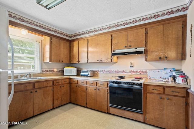 701 Ledoux St, Jennings, LA 70546 - kitchen with under cabinet range hood, white appliances, light countertops, brown cabinetry, and a textured ceiling