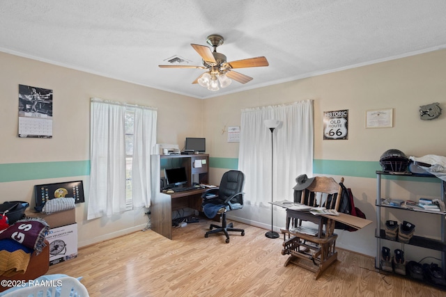 701 Ledoux St, Jennings, LA 70546 - home office with wood finished floors, a ceiling fan, crown molding, and a textured ceiling