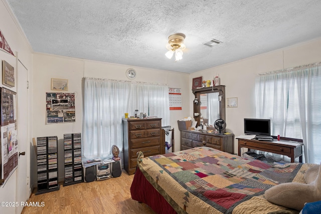 701 Ledoux St, Jennings, LA 70546 - bedroom featuring a textured ceiling and light wood-type flooring