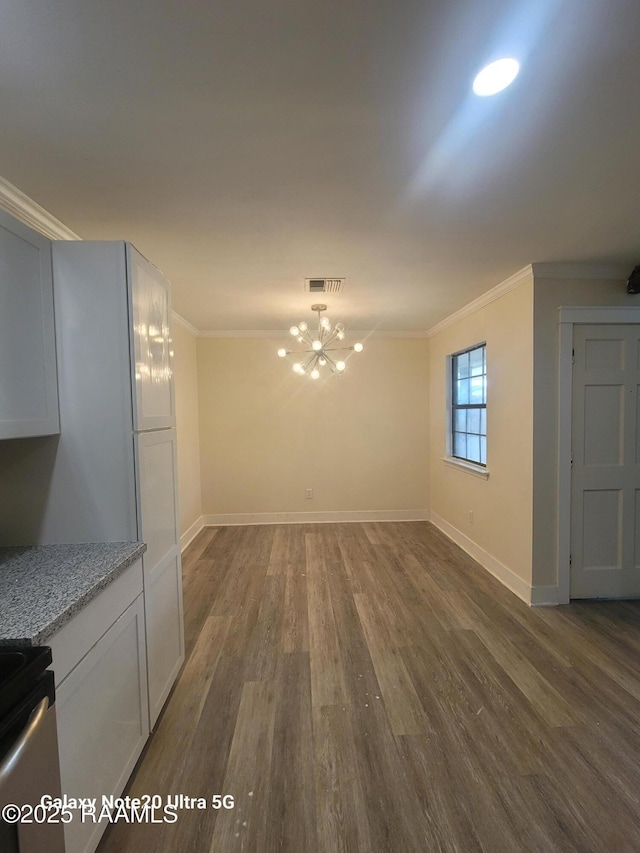 117 Luna St, Lafayette, LA 70506 - unfurnished dining area featuring ornamental molding, dark wood-style floors, and a chandelier