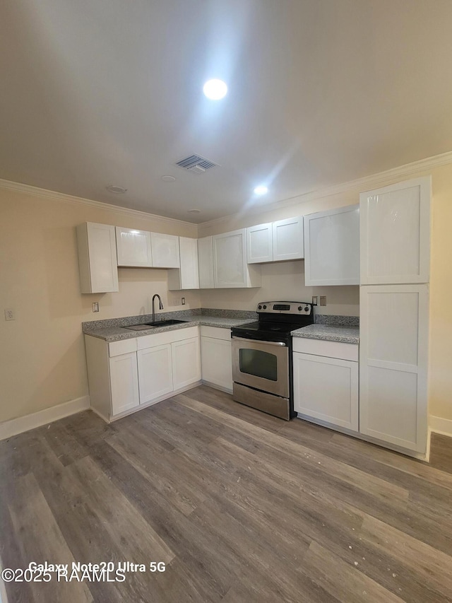 117 Luna St, Lafayette, LA 70506 - kitchen with stainless steel range with electric stovetop, crown molding, dark wood finished floors, white cabinets, and recessed lighting
