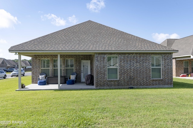 100 Rose Of Sharon Ln, Lafayette, LA 70508 - rear view of property with roof with shingles, a patio area, brick siding, and a lawn