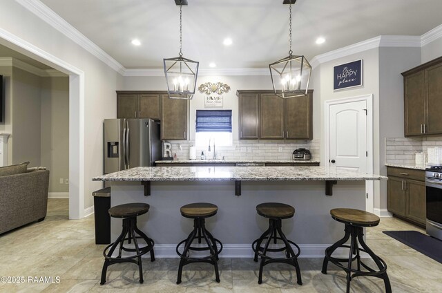 100 Rose Of Sharon Ln, Lafayette, LA 70508 - kitchen with stainless steel appliances, dark brown cabinets, backsplash, a kitchen bar, and recessed lighting