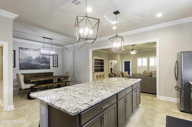 100 Rose Of Sharon Ln, Lafayette, LA 70508 - kitchen featuring freestanding refrigerator, ornamental molding, light stone counters, dark brown cabinets, and decorative light fixtures