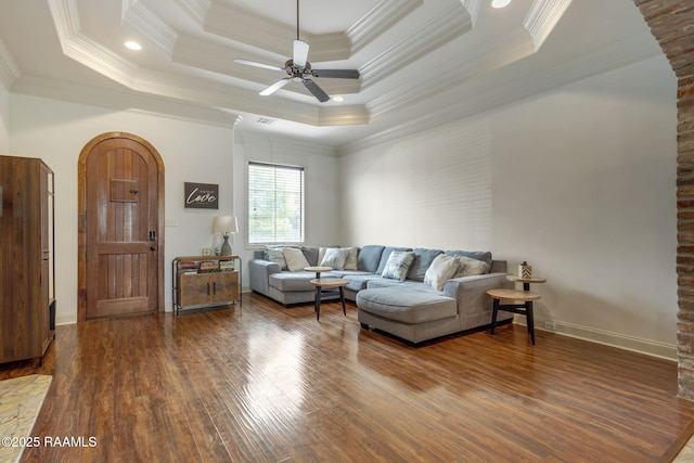 103 Majestic Oaks Dr, Broussard, LA 70518 - living room with wood finished floors, a ceiling fan, crown molding, arched walkways, and a raised ceiling
