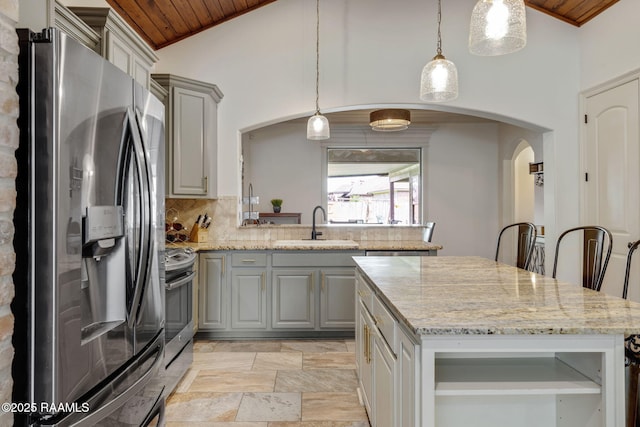 103 Majestic Oaks Dr, Broussard, LA 70518 - kitchen featuring appliances with stainless steel finishes, gray cabinetry, arched walkways, wooden ceiling, and light stone finish floors