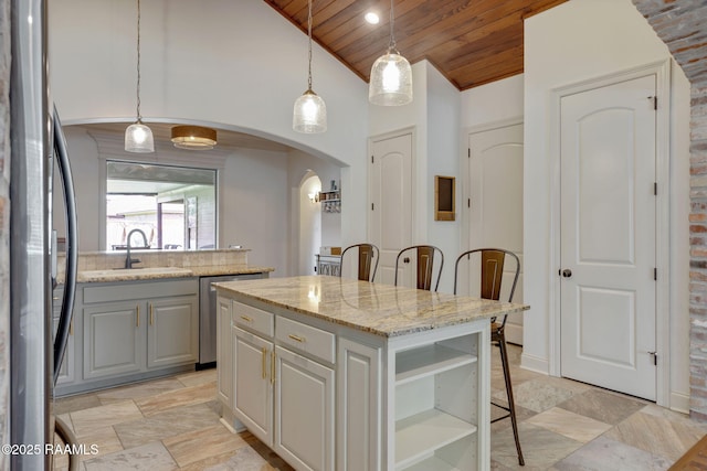 103 Majestic Oaks Dr, Broussard, LA 70518 - kitchen with stainless steel appliances, wooden ceiling, open shelves, arched walkways, and a center island