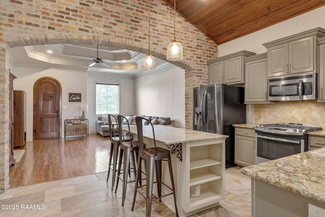 103 Majestic Oaks Dr, Broussard, LA 70518 - kitchen with appliances with stainless steel finishes, arched walkways, gray cabinets, ceiling fan, and open floor plan