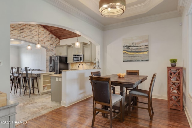 103 Majestic Oaks Dr, Broussard, LA 70518 - dining area featuring arched walkways, lofted ceiling, wood finished floors, and crown molding
