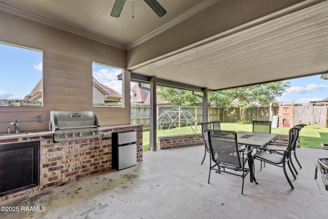 103 Majestic Oaks Dr, Broussard, LA 70518 - fenced backyard with outdoor dining area, an outdoor kitchen, a patio area, and a ceiling fan