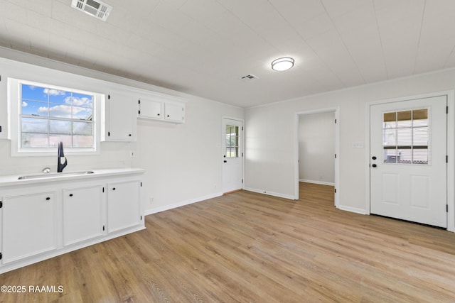 189 Jeremy Rd, Opelousas, LA 70570 - kitchen featuring light countertops, white cabinetry, and light wood-style flooring