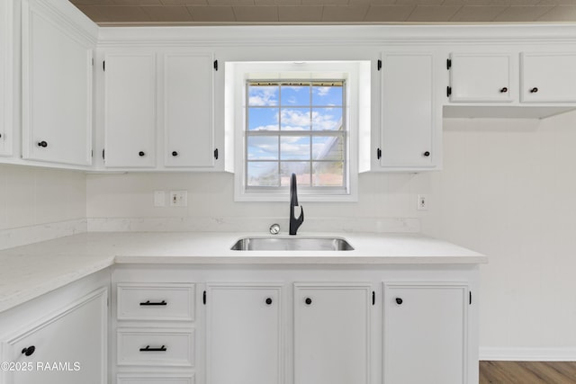 189 Jeremy Rd, Opelousas, LA 70570 - kitchen featuring white cabinetry, light countertops, and wood finished floors