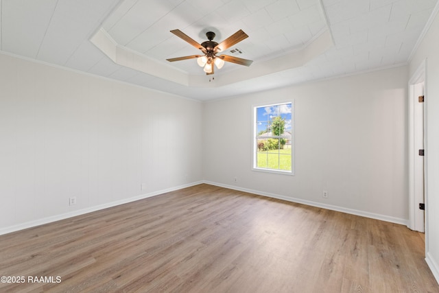 189 Jeremy Rd, Opelousas, LA 70570 - empty room featuring a tray ceiling, light wood-style floors, ornamental molding, and ceiling fan