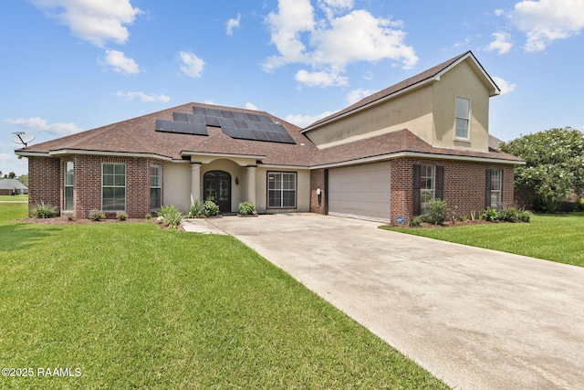 742 Hummingbird Ln, New Iberia, LA 70563 - view of front of home with solar panels, brick siding, a front lawn, concrete driveway, and stucco siding