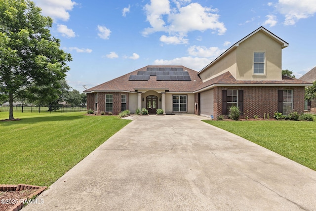 742 Hummingbird Ln, New Iberia, LA 70563 - view of front of property with concrete driveway, solar panels, brick siding, and an attached garage