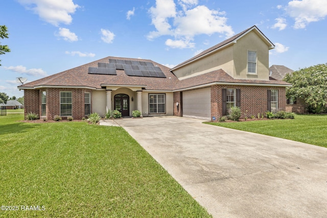742 Hummingbird Ln, New Iberia, LA 70563 - view of front of home featuring roof mounted solar panels, a front lawn, driveway, stucco siding, and a garage