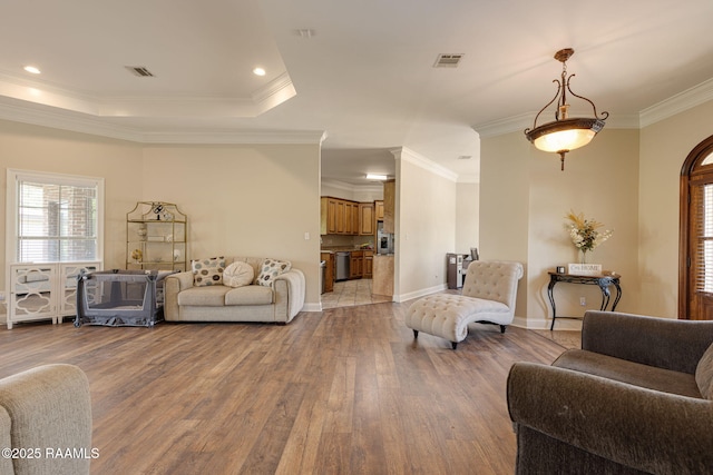 742 Hummingbird Ln, New Iberia, LA 70563 - living area with wood finished floors, plenty of natural light, and crown molding